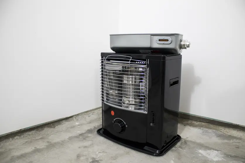 Black kerosene heater in a white background composition