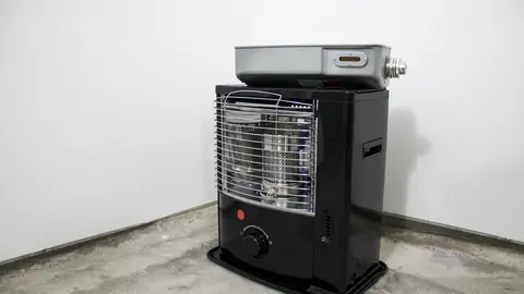 Black kerosene heater in a white background composition